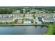 Aerial view of a community featuring a pool, playground, and lake with a fountain at 6863 Tussilago Way, Orlando, FL 32822