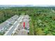 Aerial view of townhomes with solar panels, backing onto a lush wooded area at 6863 Tussilago Way, Orlando, FL 32822
