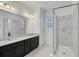 Modern bathroom featuring a spacious granite counter, a walk-in shower and updated lighting at 6863 Tussilago Way, Orlando, FL 32822