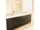 Modern bathroom featuring granite countertops, dual sinks, and a large shower with a glass door at 6863 Tussilago Way, Orlando, FL 32822
