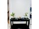 Chic entryway display with a black console table, decorative vases, and artful floral arrangements at 6863 Tussilago Way, Orlando, FL 32822