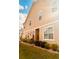 Side view of a two-story home showcasing a well-maintained lawn and tasteful exterior siding at 6863 Tussilago Way, Orlando, FL 32822