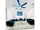 Elegant living room with plush velvet sofas, a modern ceiling fan, and a decorative area rug at 6863 Tussilago Way, Orlando, FL 32822
