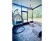 Cozy screened patio with hanging chair and outdoor seating area at 6863 Tussilago Way, Orlando, FL 32822