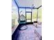 Charming screened patio with hanging chair, perfect for relaxing outdoors at 6863 Tussilago Way, Orlando, FL 32822