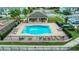 Aerial view of a community pool with lounge chairs, tables and shady pavilion at 6863 Tussilago Way, Orlando, FL 32822
