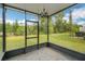 Cozy screened-in porch with brick flooring, providing a serene outdoor living space at 6863 Tussilago Way, Orlando, FL 32822