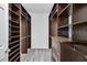 Custom walk-in closet featuring dark shelving and storage drawers at 6863 Tussilago Way, Orlando, FL 32822