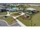 Community playground with shade structure, slides, and adjacent pool area surrounded by green space at 7138 Rolling Leaf Rd, Groveland, FL 34736