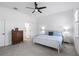 Bright bedroom featuring a ceiling fan, white trim, carpeted floors, and natural light at 779 Firerock Ln, Debary, FL 32713