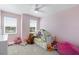 Bright bedroom features carpeted floors, natural light and soft pink colored walls at 779 Firerock Ln, Debary, FL 32713
