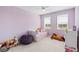 Bright bedroom features carpeted floors, natural light and soft pastel colored walls at 779 Firerock Ln, Debary, FL 32713