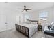 Inviting bedroom with a large bed, soft carpet, and natural light from the windows at 779 Firerock Ln, Debary, FL 32713