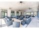 Community clubhouse featuring an open floor plan with wicker furniture, ceiling fans and tiled flooring at 779 Firerock Ln, Debary, FL 32713