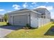 Two-story home featuring an attached gray two-car garage and well-maintained landscaping at 779 Firerock Ln, Debary, FL 32713