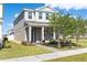 Charming two-story home featuring a landscaped front yard with fresh green grass and healthy trees at 779 Firerock Ln, Debary, FL 32713