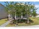 Charming two-story home featuring a landscaped front yard with fresh green grass and healthy trees at 779 Firerock Ln, Debary, FL 32713