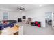 Spacious living area featuring plush seating, TV, and an adjacent play area at 779 Firerock Ln, Debary, FL 32713