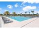 An inviting community pool with lounge chairs and palm trees, providing a serene retreat at 779 Firerock Ln, Debary, FL 32713