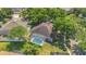 Birds eye view of a home that has a screened in pool with well manicured property and trees at 8061 Bangle Ln, Orlando, FL 32836