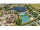 The view showcases community amenities like a pool, tennis courts, and picturesque lake at 8061 Bangle Ln, Orlando, FL 32836