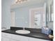 Well-lit bathroom with a large mirror, modern fixtures, and a view to an adjacent room at 8061 Bangle Ln, Orlando, FL 32836