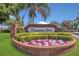 Diamond Cove community entrance featuring colorful flowers and lush landscaping under clear blue skies at 8061 Bangle Ln, Orlando, FL 32836