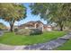 Traditional home showcasing a well-kept lawn, mature trees, and a welcoming facade with an attached garage at 8061 Bangle Ln, Orlando, FL 32836