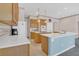 Charming kitchen featuring white countertops, wood cabinetry, and a stylish blue breakfast bar at 8061 Bangle Ln, Orlando, FL 32836