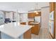 Open-concept kitchen with quartz countertops, stainless steel appliances and white cabinets at 8061 Bangle Ln, Orlando, FL 32836