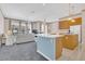 Open-concept living room with a view of kitchen, large windows, and comfortable seating at 8061 Bangle Ln, Orlando, FL 32836