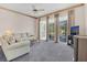 Inviting living room featuring a comfortable sofa and sliding glass doors at 8061 Bangle Ln, Orlando, FL 32836