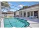 The backyard features a screened-in pool, patio and outdoor seating area, perfect for relaxing at 8061 Bangle Ln, Orlando, FL 32836