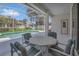 The covered lanai has an outdoor dining area overlooking the screened-in pool and yard at 8061 Bangle Ln, Orlando, FL 32836