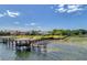 Waterfront property with a gazebo, dock, lush lawns, and a large screened in pool at 9018 Southern Breeze Dr, Orlando, FL 32836