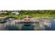 Aerial view featuring gazebo, luxurious home with screened pool, and lush landscaping on the waterfront at 9018 Southern Breeze Dr, Orlando, FL 32836
