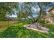 Lush backyard with mature trees providing shade, features a stone patio ideal for relaxation at 9018 Southern Breeze Dr, Orlando, FL 32836