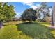 Expansive backyard featuring lush lawn, mature trees, and a black fence that offers ample space at 9018 Southern Breeze Dr, Orlando, FL 32836