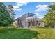 The backyard features a screened-in enclosure, providing a bug-free space for outdoor relaxation and entertainment at 9018 Southern Breeze Dr, Orlando, FL 32836