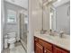Bright bathroom with glass-enclosed shower, neutral colored walls, and wood vanity at 9018 Southern Breeze Dr, Orlando, FL 32836