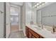 Bathroom with a vanity, large mirror, and tiled floors at 9018 Southern Breeze Dr, Orlando, FL 32836