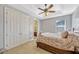Cozy bedroom featuring a ceiling fan and access to ensuite bathroom at 9018 Southern Breeze Dr, Orlando, FL 32836