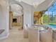 Bright breakfast nook with glass table, cushioned seating overlooking pool and outdoor entertainment space at 9018 Southern Breeze Dr, Orlando, FL 32836