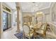 Elegant dining room with a crystal chandelier, decorative columns, and luxury furniture at 9018 Southern Breeze Dr, Orlando, FL 32836