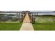 Wooden dock extends over lake with gazebo, lush lily pads, and calming water views at 9018 Southern Breeze Dr, Orlando, FL 32836