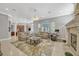 Open-concept living room features a fireplace, large windows, and neutral decor at 9018 Southern Breeze Dr, Orlando, FL 32836