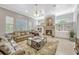Comfortable living room featuring a cozy fireplace, built-in shelving, and large windows at 9018 Southern Breeze Dr, Orlando, FL 32836