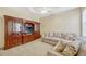 Spacious living room with comfortable seating, built-in wooden cabinets, and neutral carpet at 9018 Southern Breeze Dr, Orlando, FL 32836