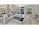 Spacious living room area with an elegant interior design, tile flooring, and gray accent walls at 9018 Southern Breeze Dr, Orlando, FL 32836
