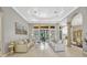 Open living room with tray ceiling, architectural pillars, tile flooring, and view of the backyard at 9018 Southern Breeze Dr, Orlando, FL 32836